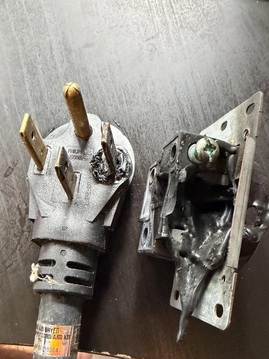 Burnt EV charger plug and NEMA 14-50 outlet from Travis Decker's garage