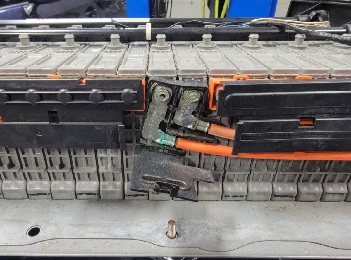 Corroded high-voltage connections and sharpie marks on a rebuilt Prius hybrid battery