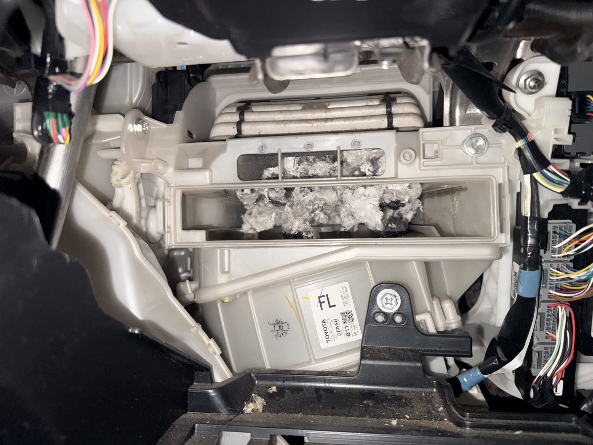 Cabin filter housing full of shredded mouse nest behind the glove box